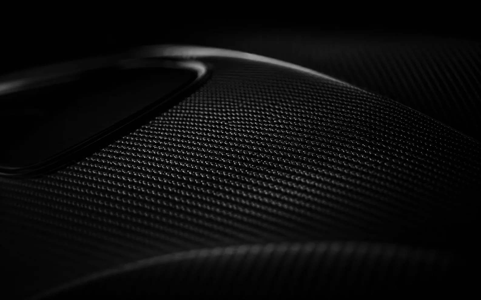 Exposed carbon weave, raking light
