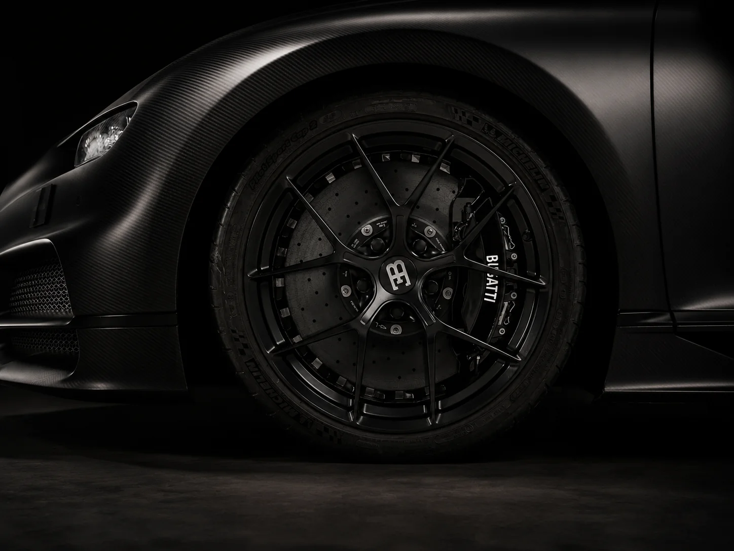 The car low and still in deep shadow